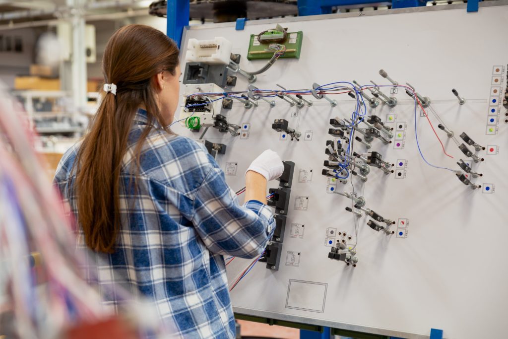 Employee working on circuit panel.